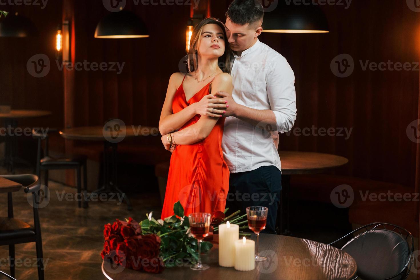 Two people standing together. Romantic couple have dinner in the restaurant photo