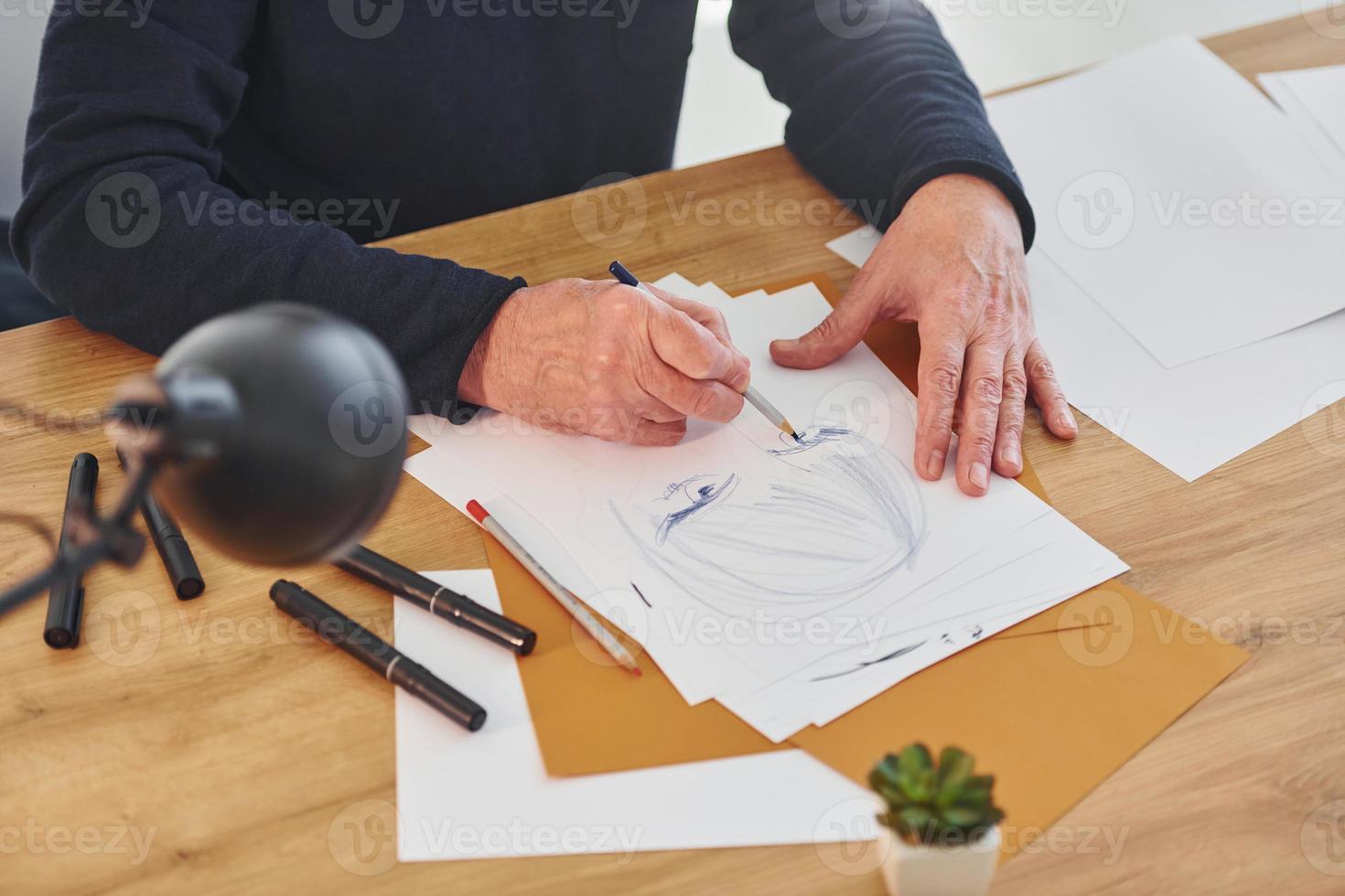 Top view of painter that working on the sketch of a man photo