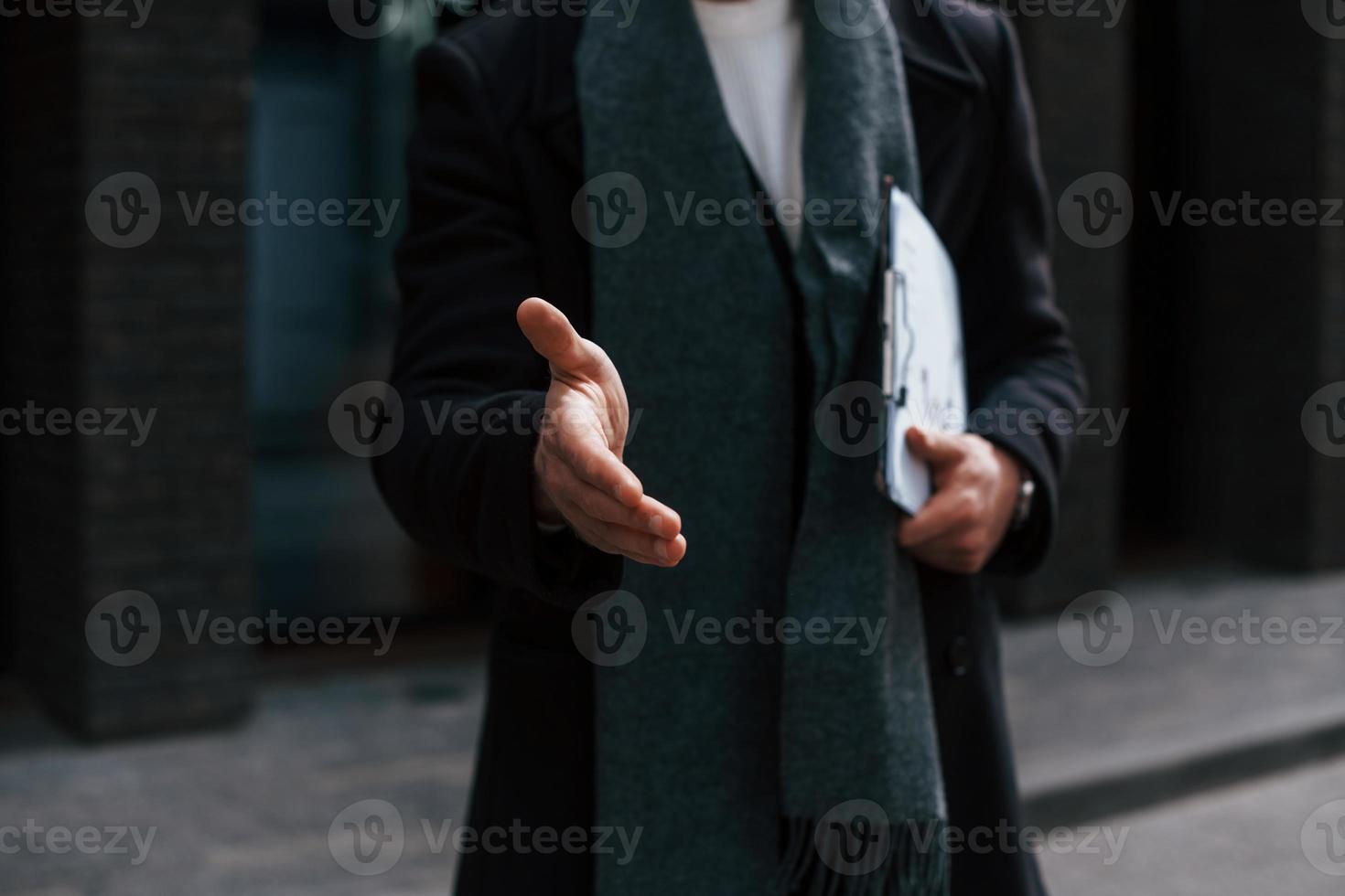 Close up view of man in formal clothes that gives hand to shake. Conception of agreement photo