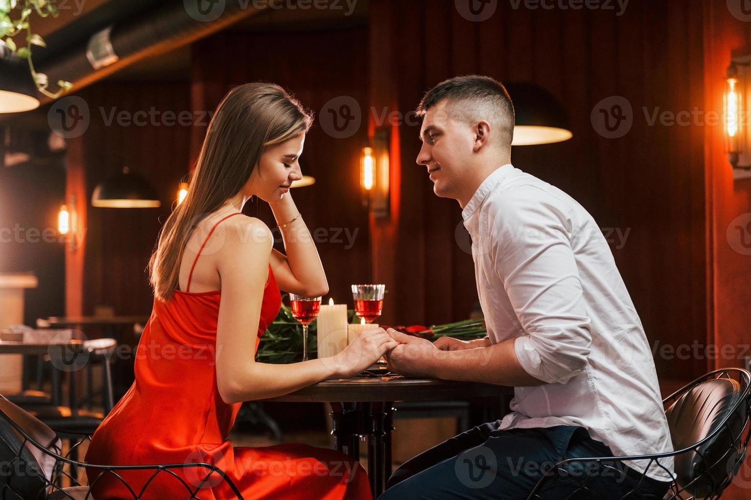 Side view. Romantic couple have dinner in the restaurant photo