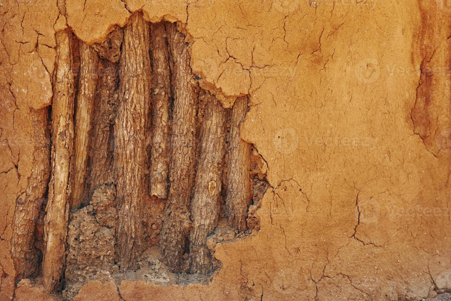 Close up view of wall maded from sand and wooden sticks photo