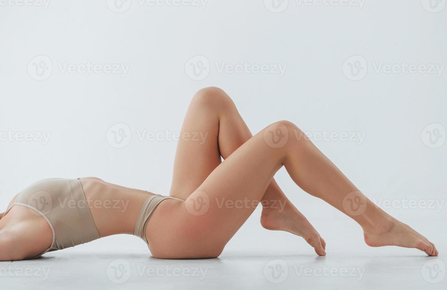 Posing on the white cube. Woman in underwear with slim body type is in the  studio 8366069 Stock Photo at Vecteezy