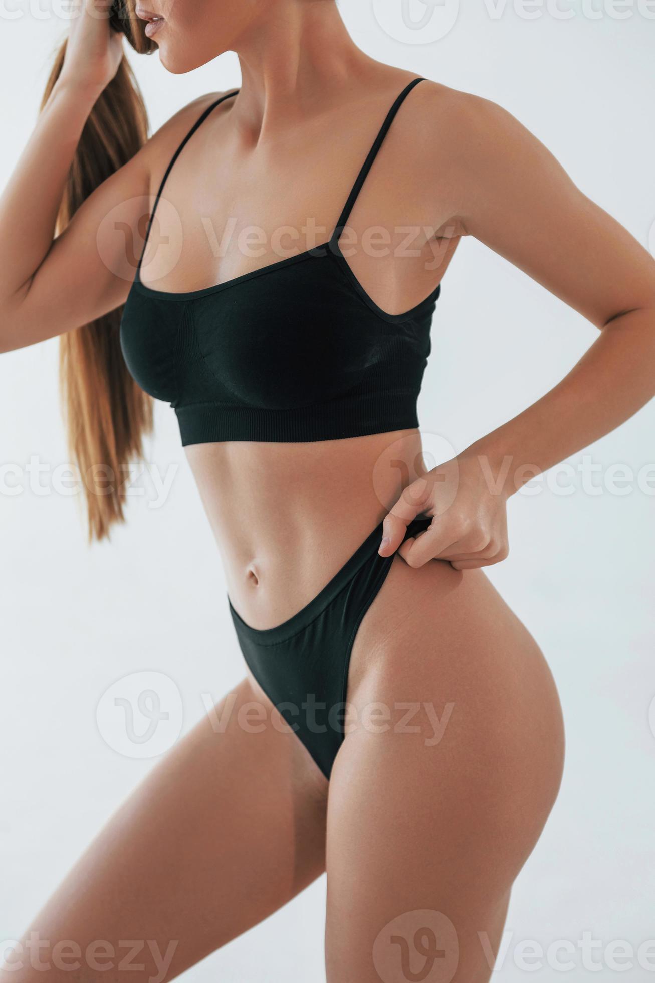 Showing new lingerie. Woman in underwear with slim body type is posing in  the studio 8365741 Stock Photo at Vecteezy