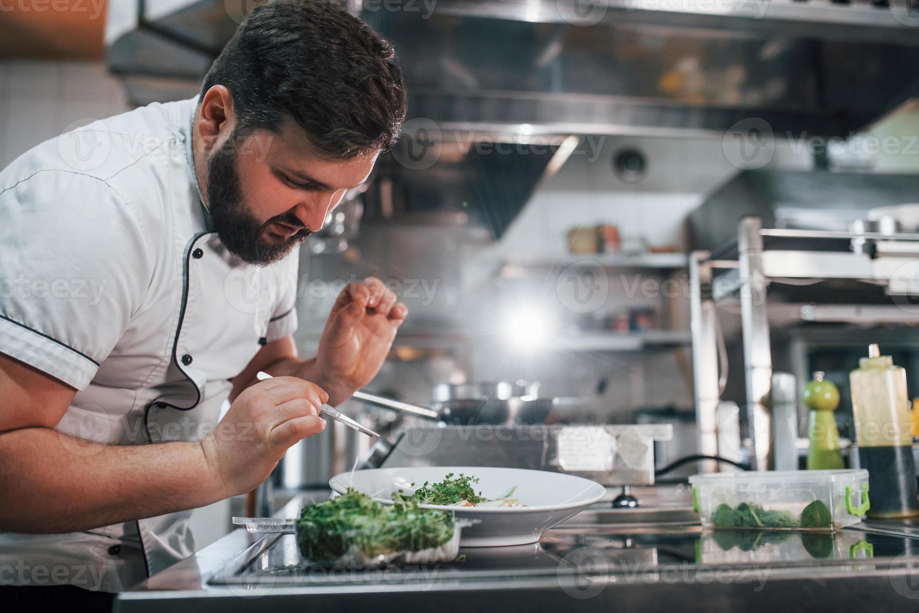 Some additional ingredients. Professional chef preparing food in the