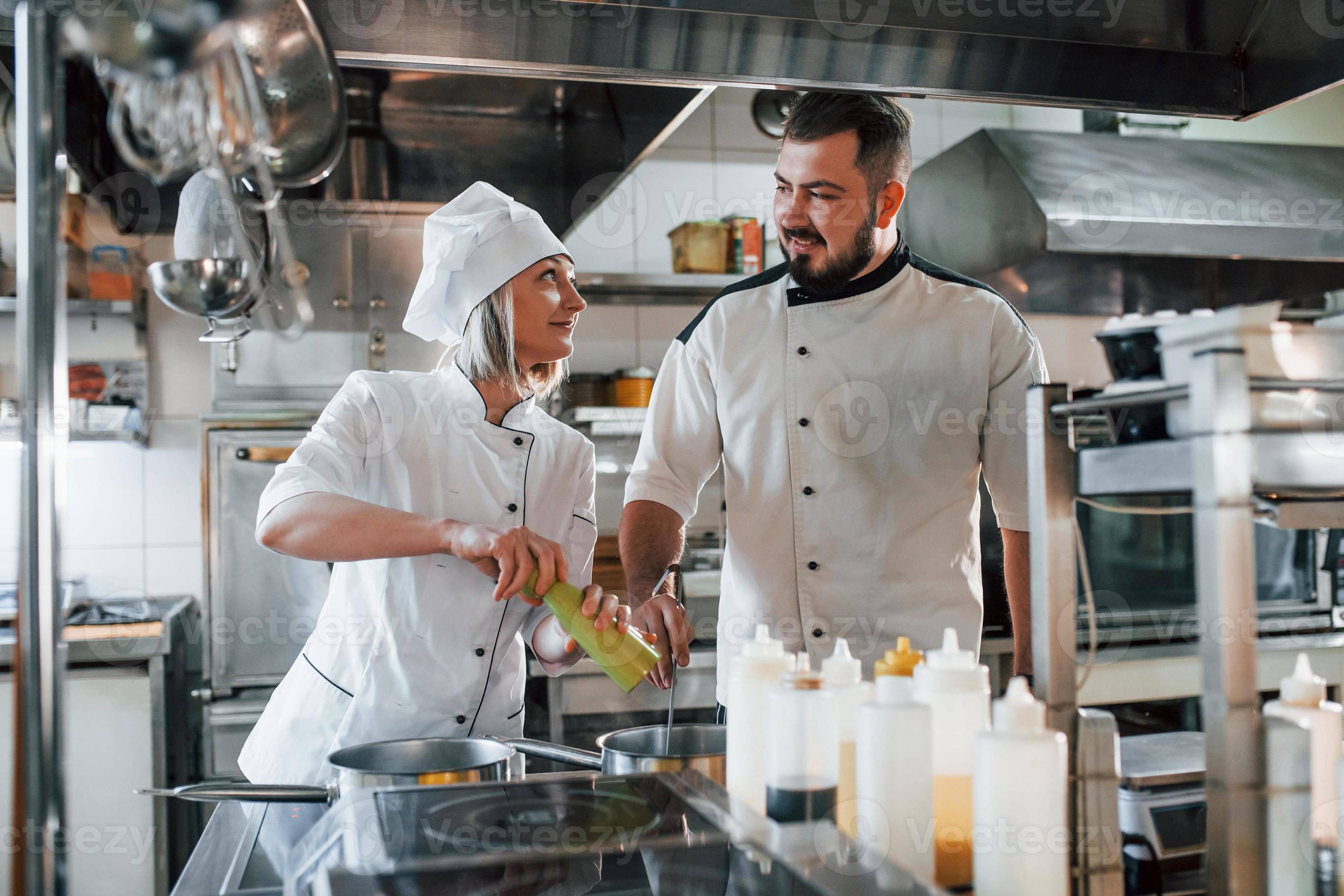 Man And Woman Cooking Meal Professional Chef Preparing Food In The