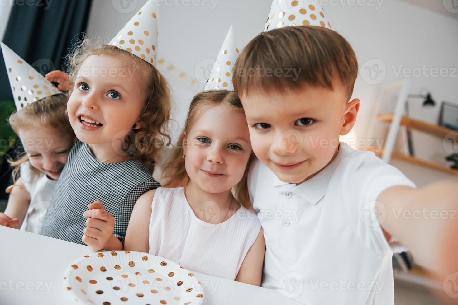 Making selfie. Celebrating brithday. Group of children is together at home at daytime photo