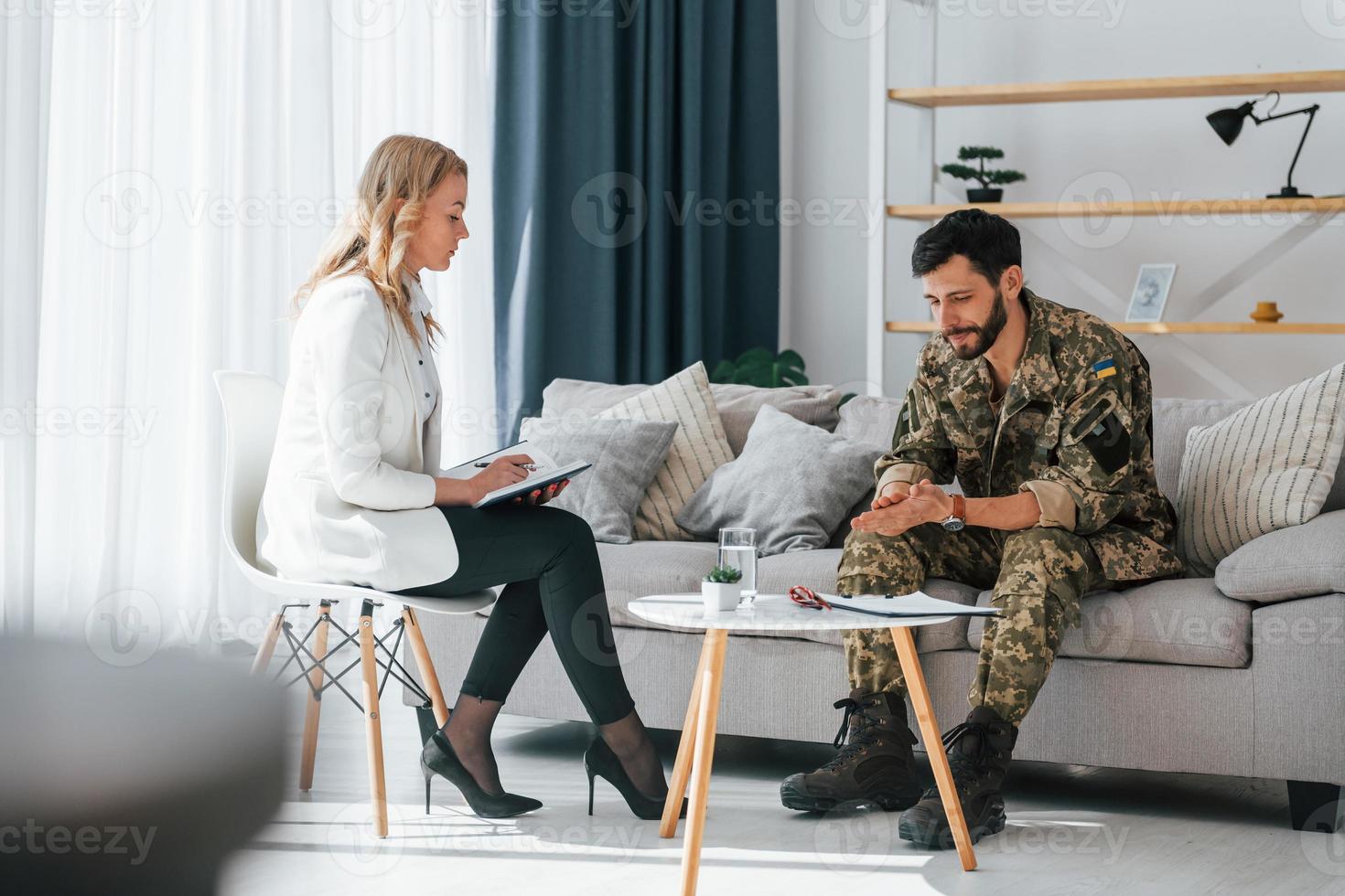 Process of therapy. Soldier is with psychologist indoors photo