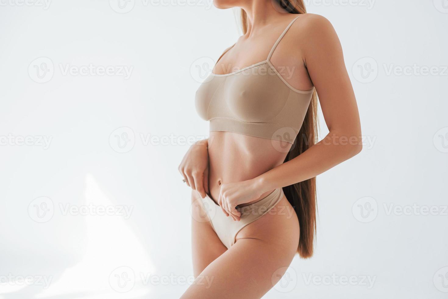Showing new lingerie. Woman in underwear with slim body type is