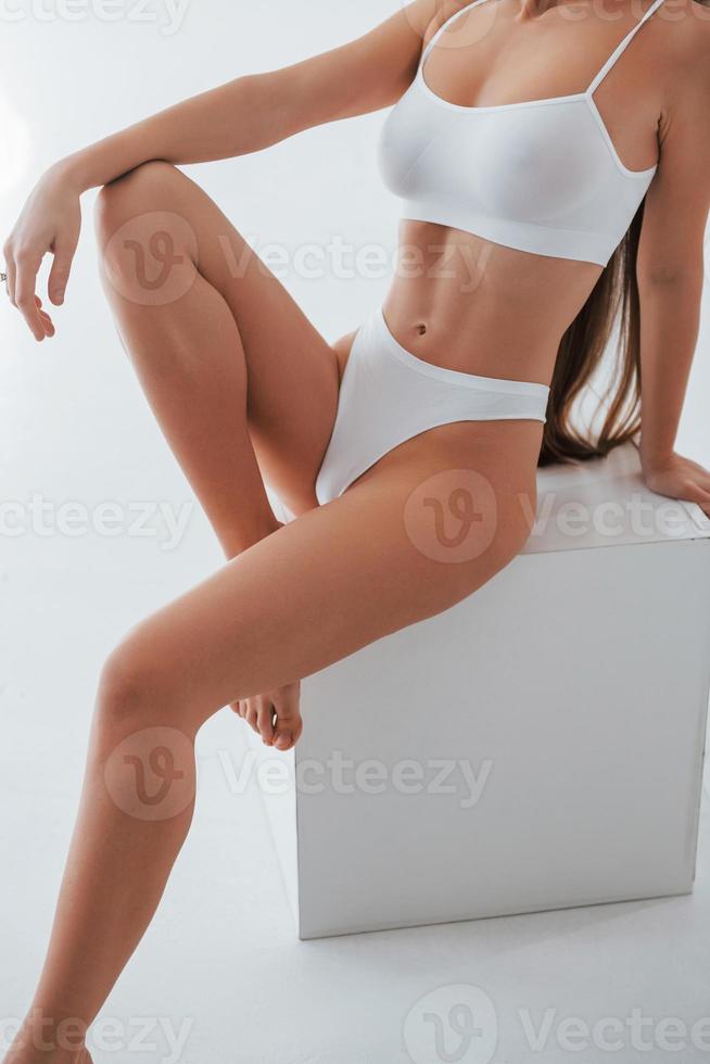 Showing new lingerie. Woman in underwear with slim body type is posing in  the studio 8365741 Stock Photo at Vecteezy
