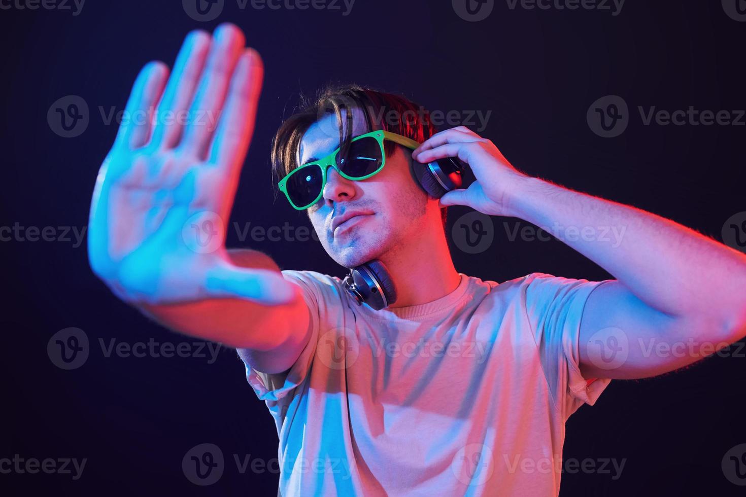 Man standing in the studio with neon light photo