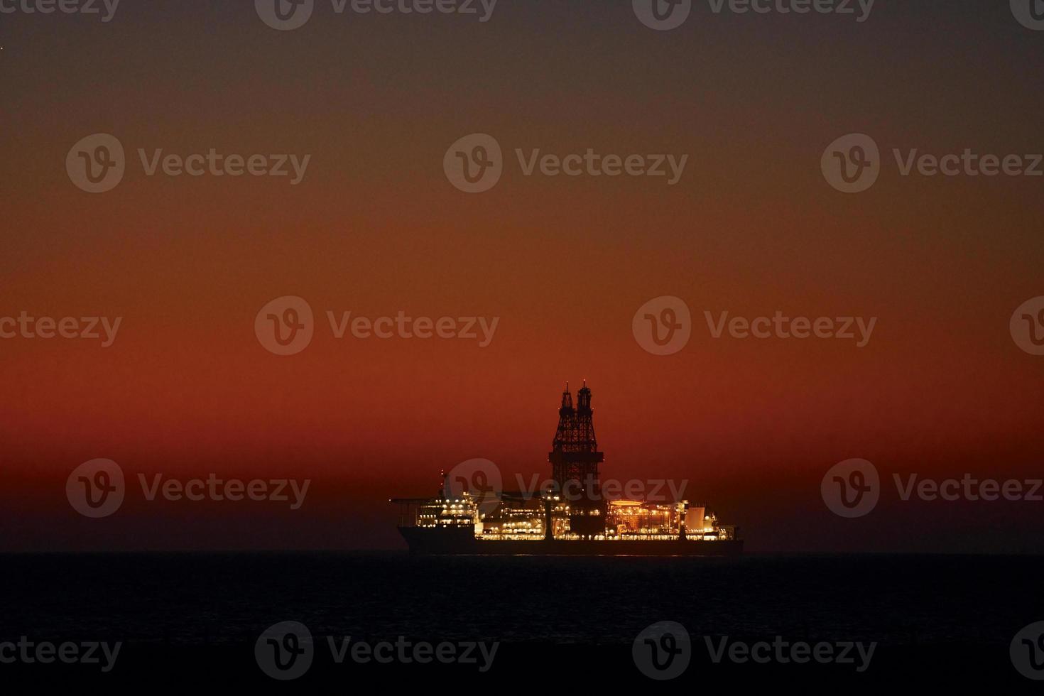 Distant majestic view of ship that is in the ocean at evening time photo