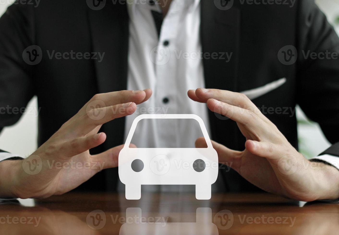 Businessman holding sign with a car symbol photo