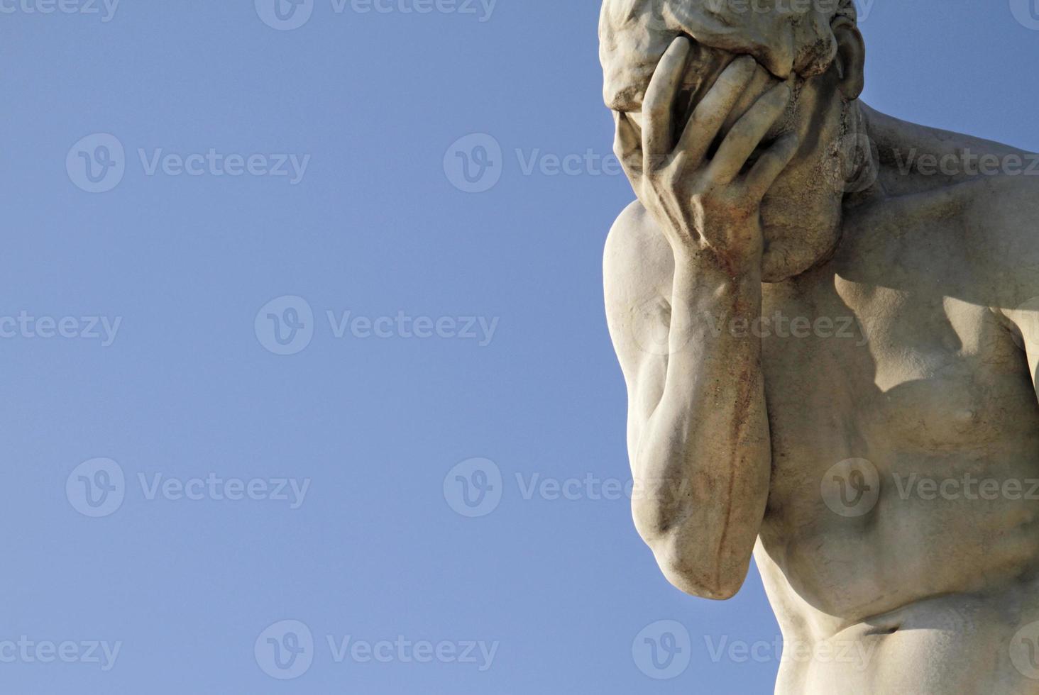 Head in hands - Statue in Paris, France photo