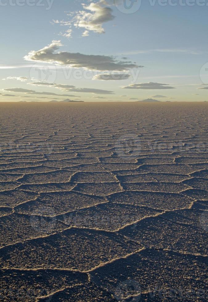 Gorgeous patterns on the surface of the salt flats of Salar de Uyuni, Bolivia, during sunset photo