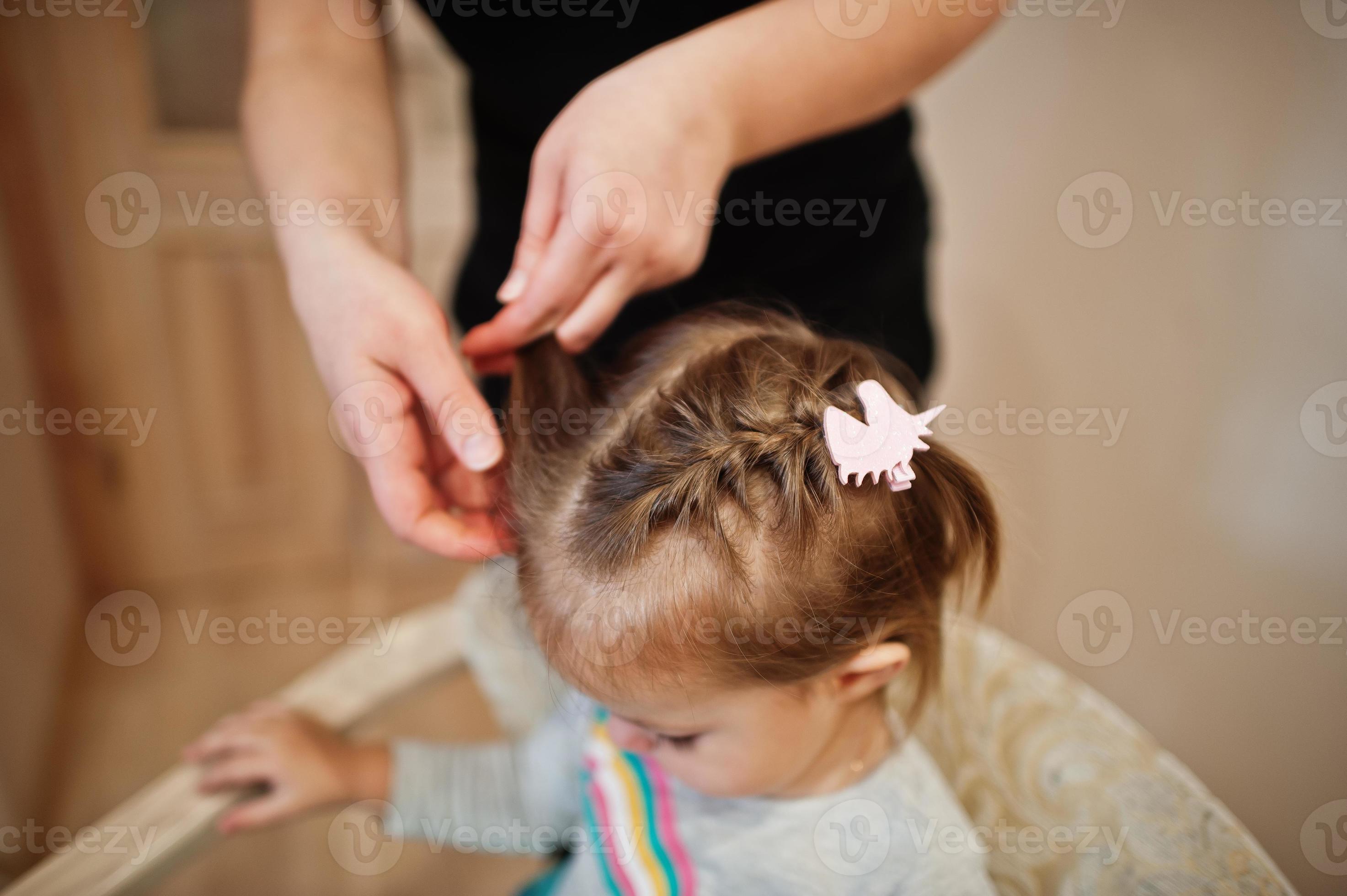 Mother and daughter weekend together at home, mom making hairstyle for baby  girl. 8368024 Stock Photo at Vecteezy