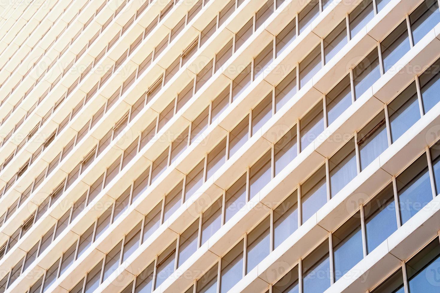 Windows of a modern business office building lit by sun rays photo