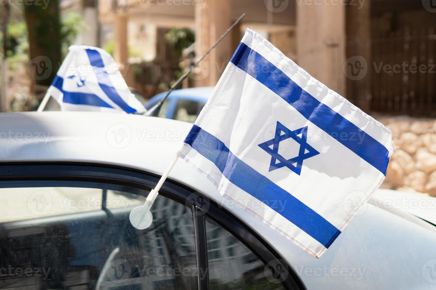 Waving on the wind israeli flags attached to the car window. photo