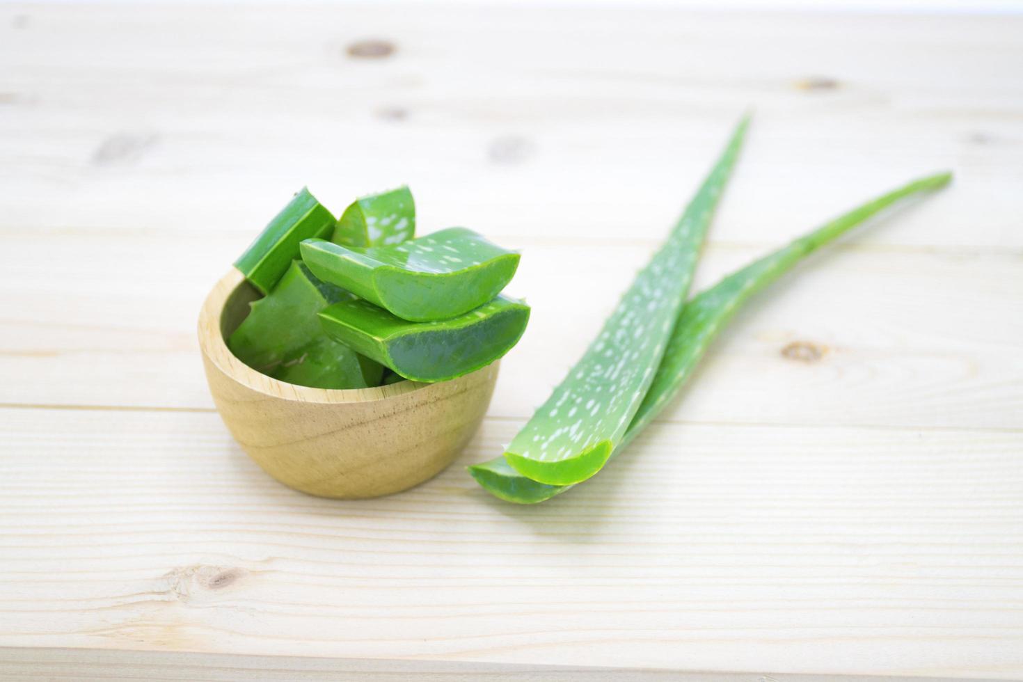 Green fresh Aloe vera sliced fresh aloe for herbal medical plant and beauty spa on wood table photo