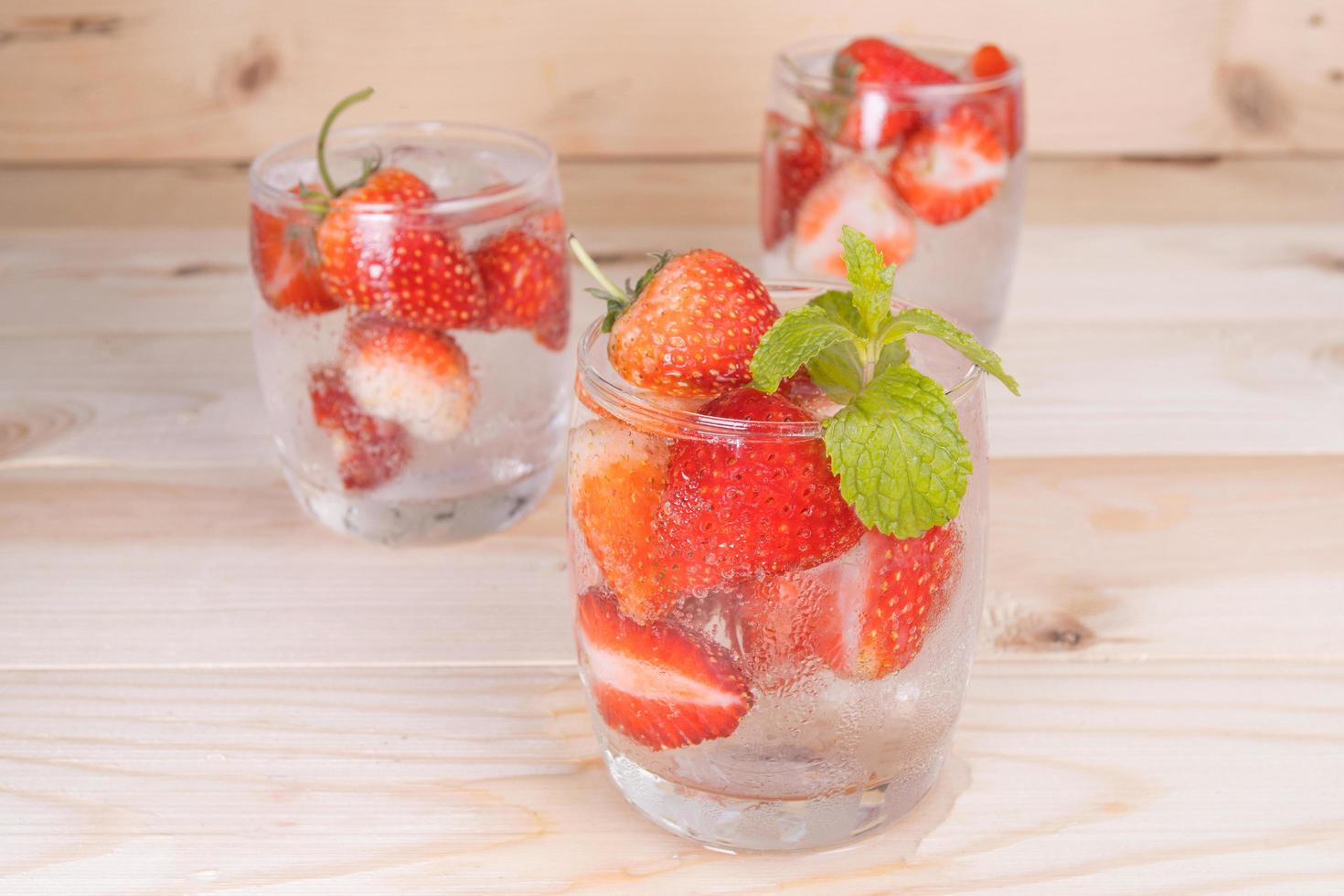 fresh Strawberry mojito cocktail with ice and mint in glass photo