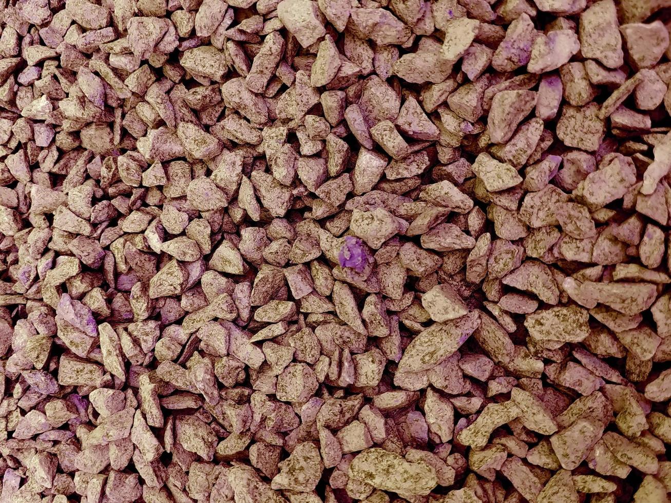 Background of magenta patterned texture of crushed stone. photo