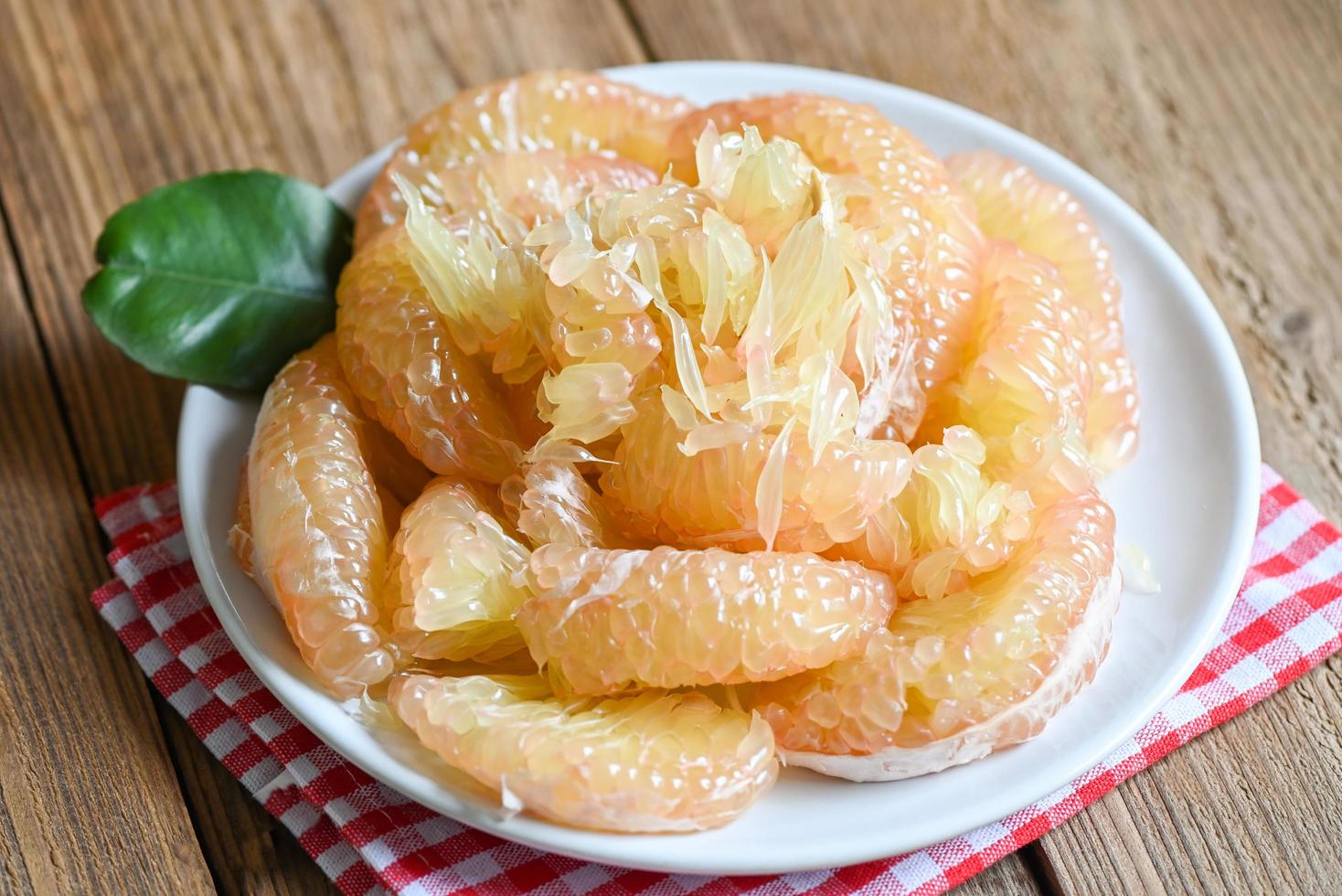 Pomelo fruit on white plate, fresh pomelo peeled frome pomelo tree , pummelo , Cloce up grapefruit in summer tropical fruit  in thailand photo