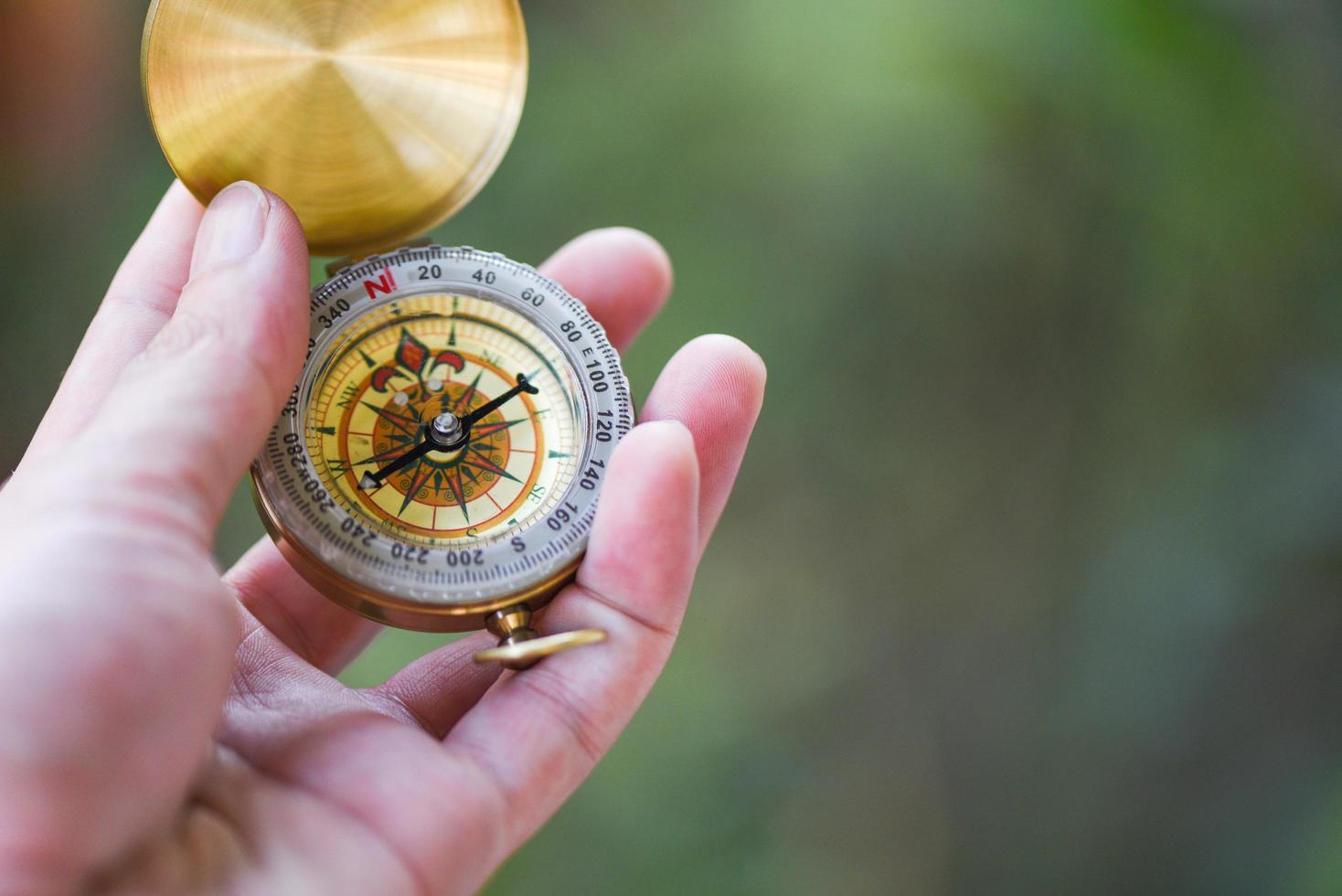 Man explorer searching direction with compass for map - Navigational compass travel and tourist concept photo