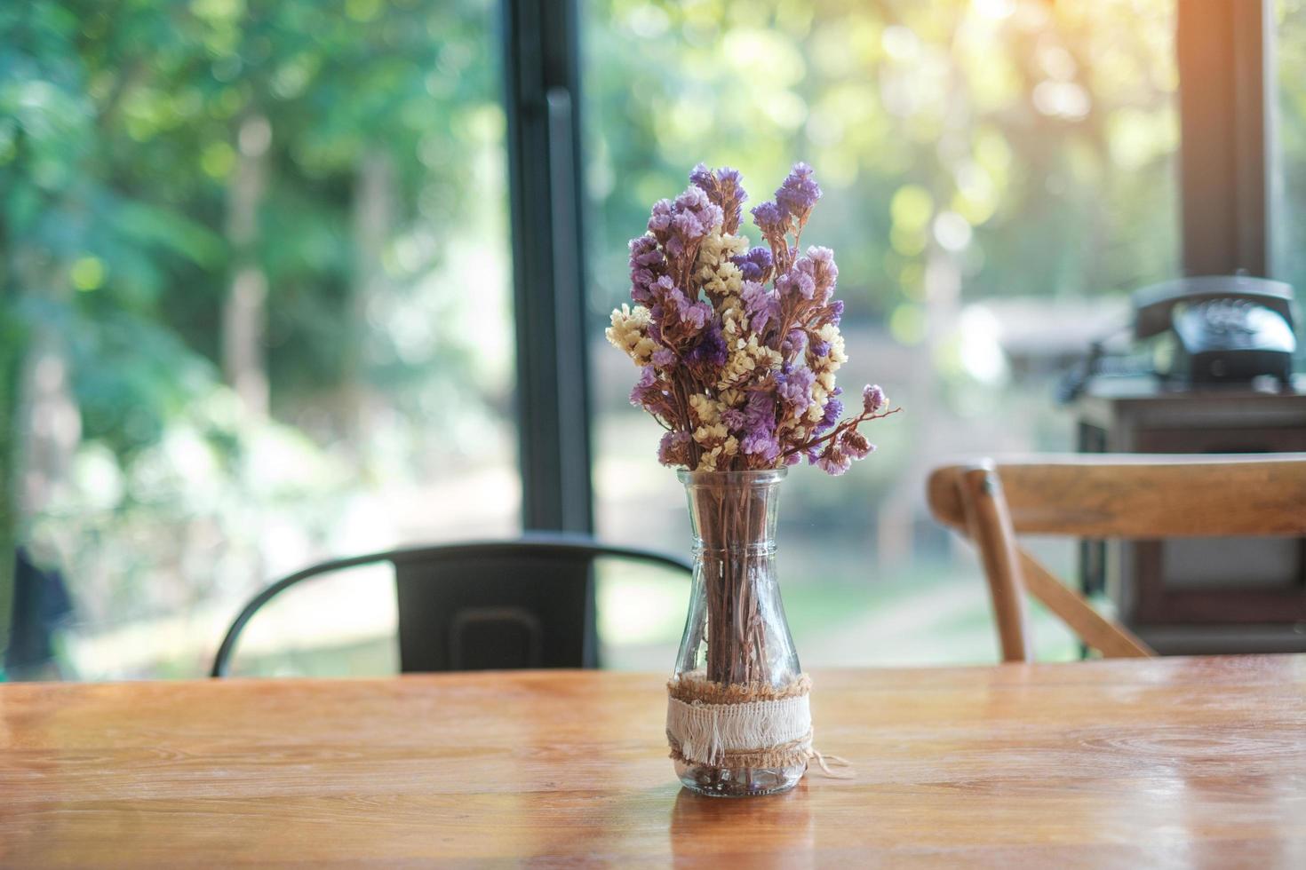Beautiful Dried statice or Sea Lavender flower Limonium spp. in glass jar on wooden table. for background with blank copy space photo