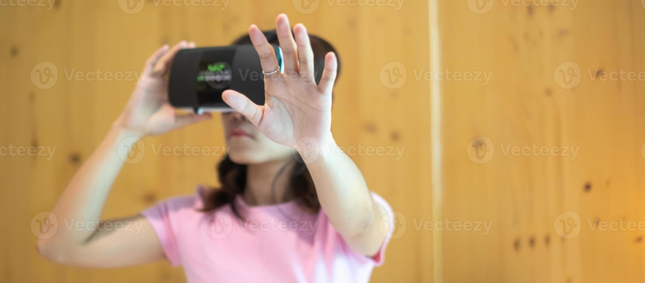 Young woman using virtual reality headset in bed. VR, Future digital technology, game, movies entertainment, metaverse, NFT and 3D cyberspace concept photo