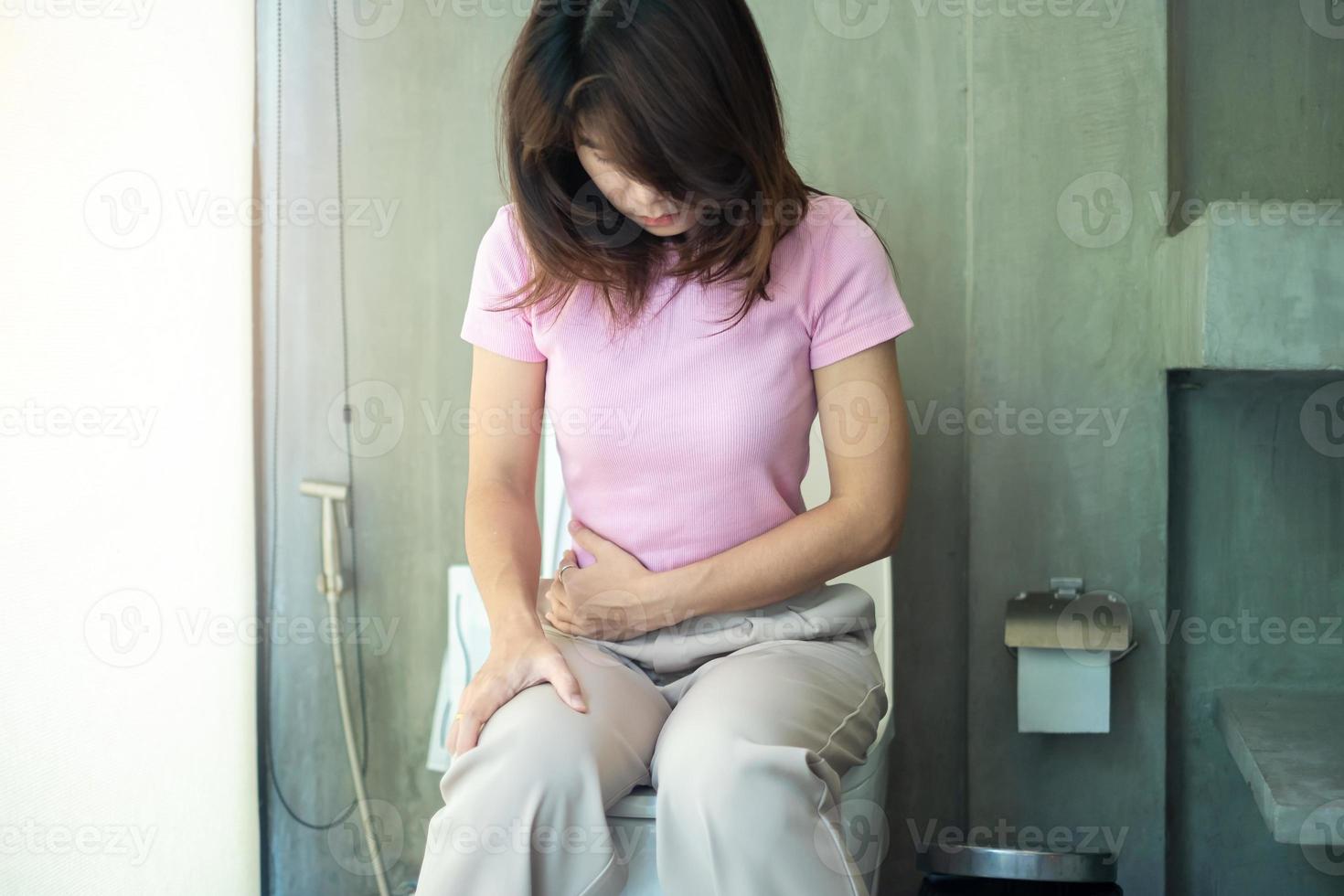 Woman sit on toilet bowl. diarrhea, constipated period, infection, abdominal, stomachache, cystitis, Insurance and Medical concept photo