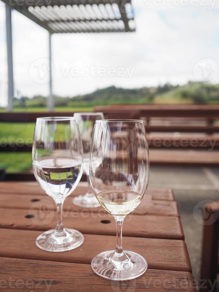 Empty Wine glasses are set on a wooden table photo