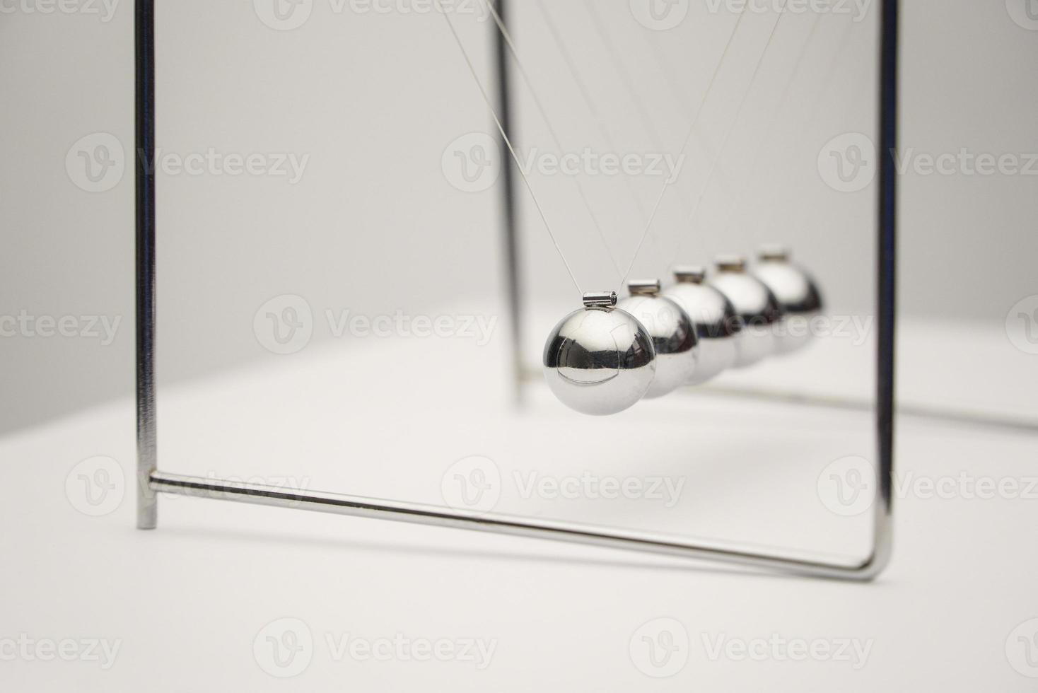 A close-up angle shot of the Newton's cradle. photo