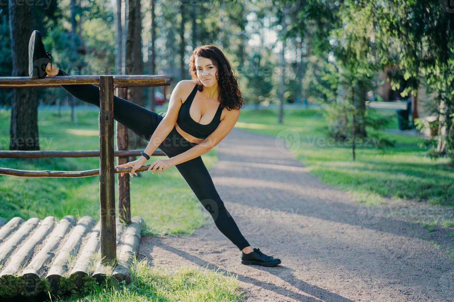 Active slim woman in sport clothes does pilates exercises and stretches  outdoor, has glad expression, good flexibility, enjoys morning workout in  fresh air. People, lifestyle, wellbeing concept 7905684 Stock Photo at  Vecteezy