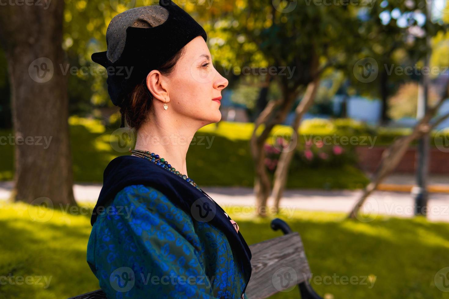Portrait of woman dressed in blue historical Baroque clothes with old fashion hairstyle, outdoors. photo