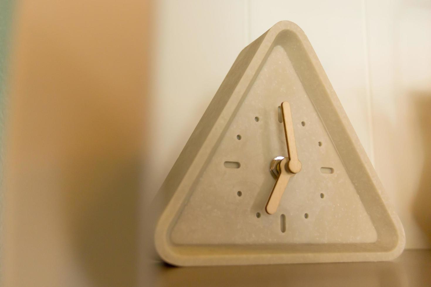 Triangle clock at seven o'clock. photo