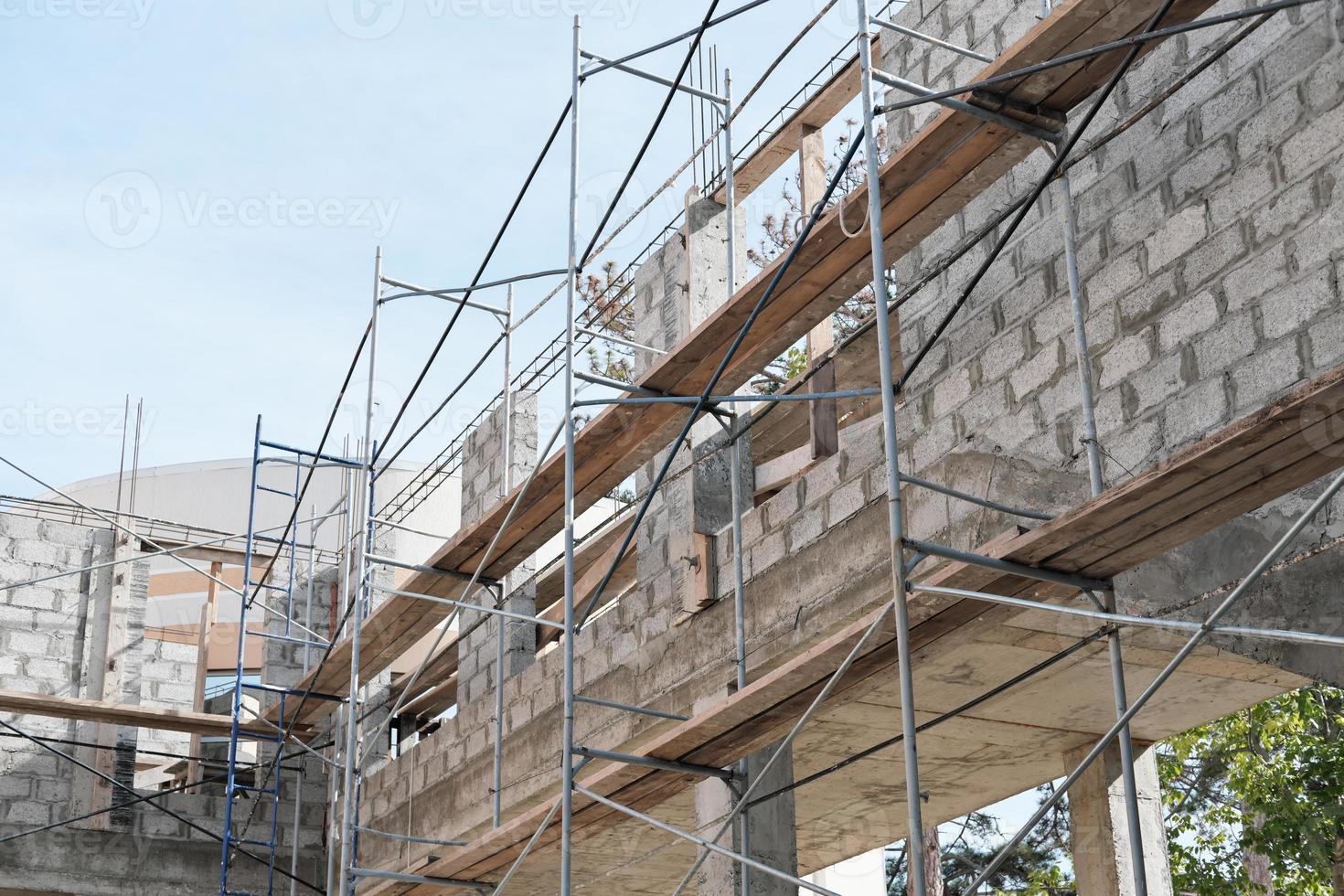 scaffolding of a brick house. reconstruction of a building photo