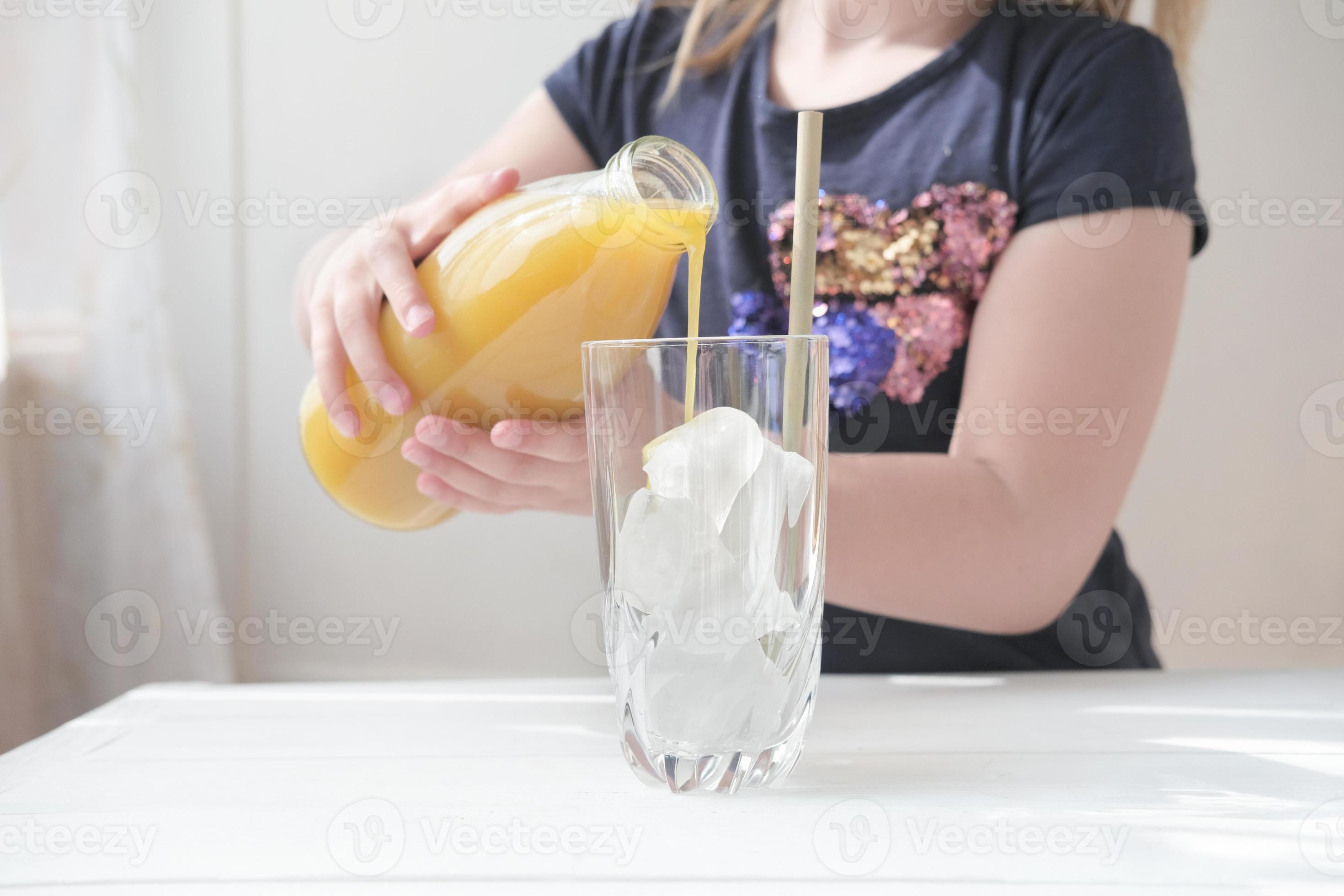 little girl pouring mango juice in a glass. 8373612 Stock Photo at Vecteezy