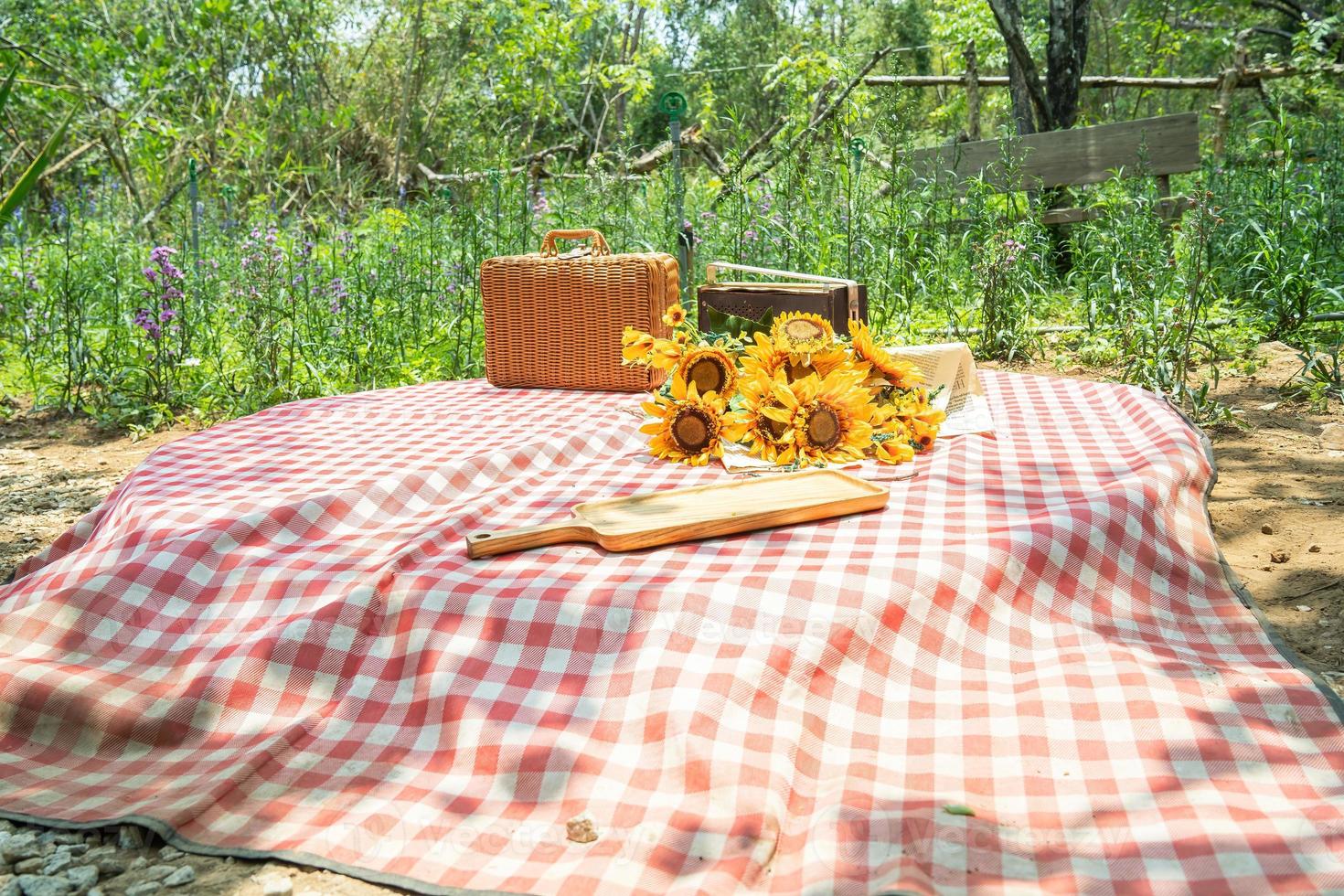 Beautiful white decor in boho style. Picnic in nature, table, carpets, wigwam, tent, pillows in the park. Celebration after quarantine. photo