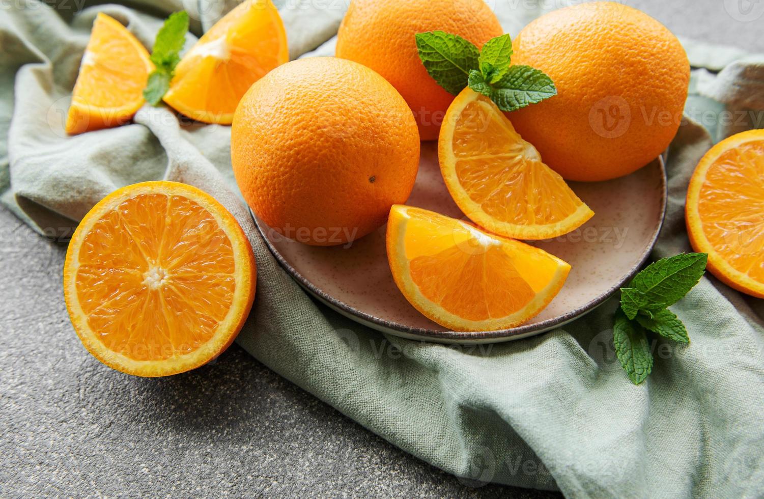 Fresh ripe oranges on concrete background photo