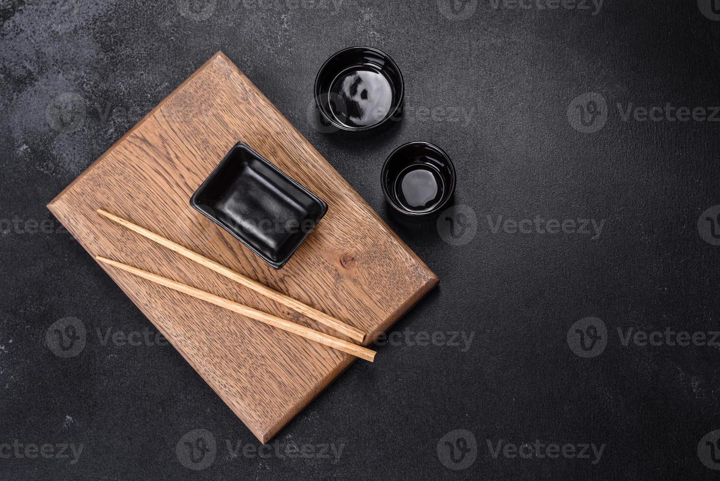 Wooden sushi sticks on a dark concrete background photo