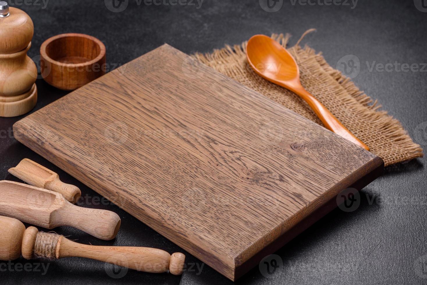 An empty wooden cutting board with wooden cutlery photo