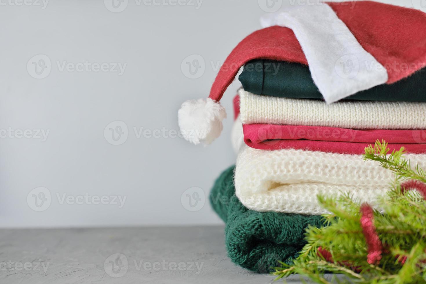 folded winter and christmas sweaters in pile photo
