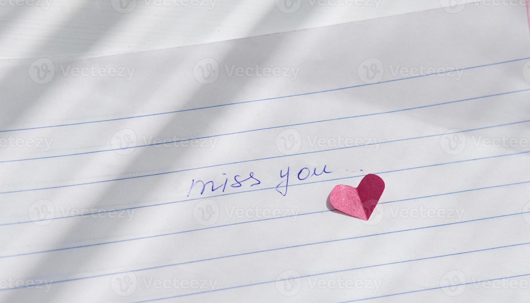 miss you note hand written on a paper. photo