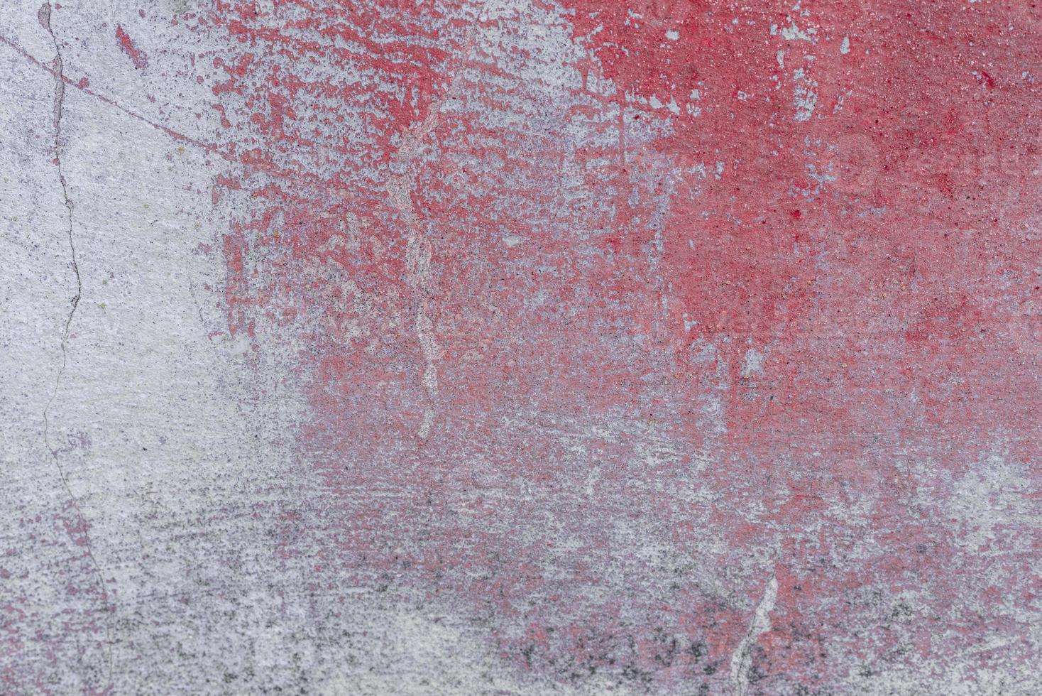 Texture of a concrete wall with cracks and scratches which can be used as a background photo