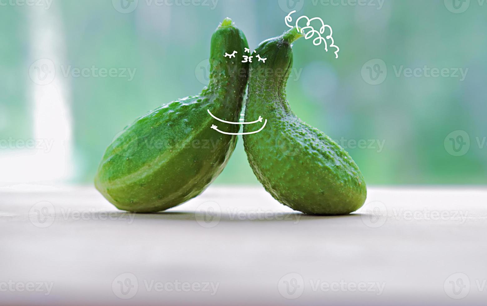 funny kissing cucumbers. cartoon characters in love. photo