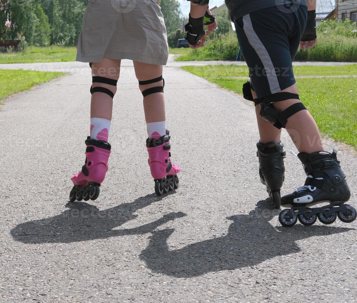 brother and sister are roller skating together photo