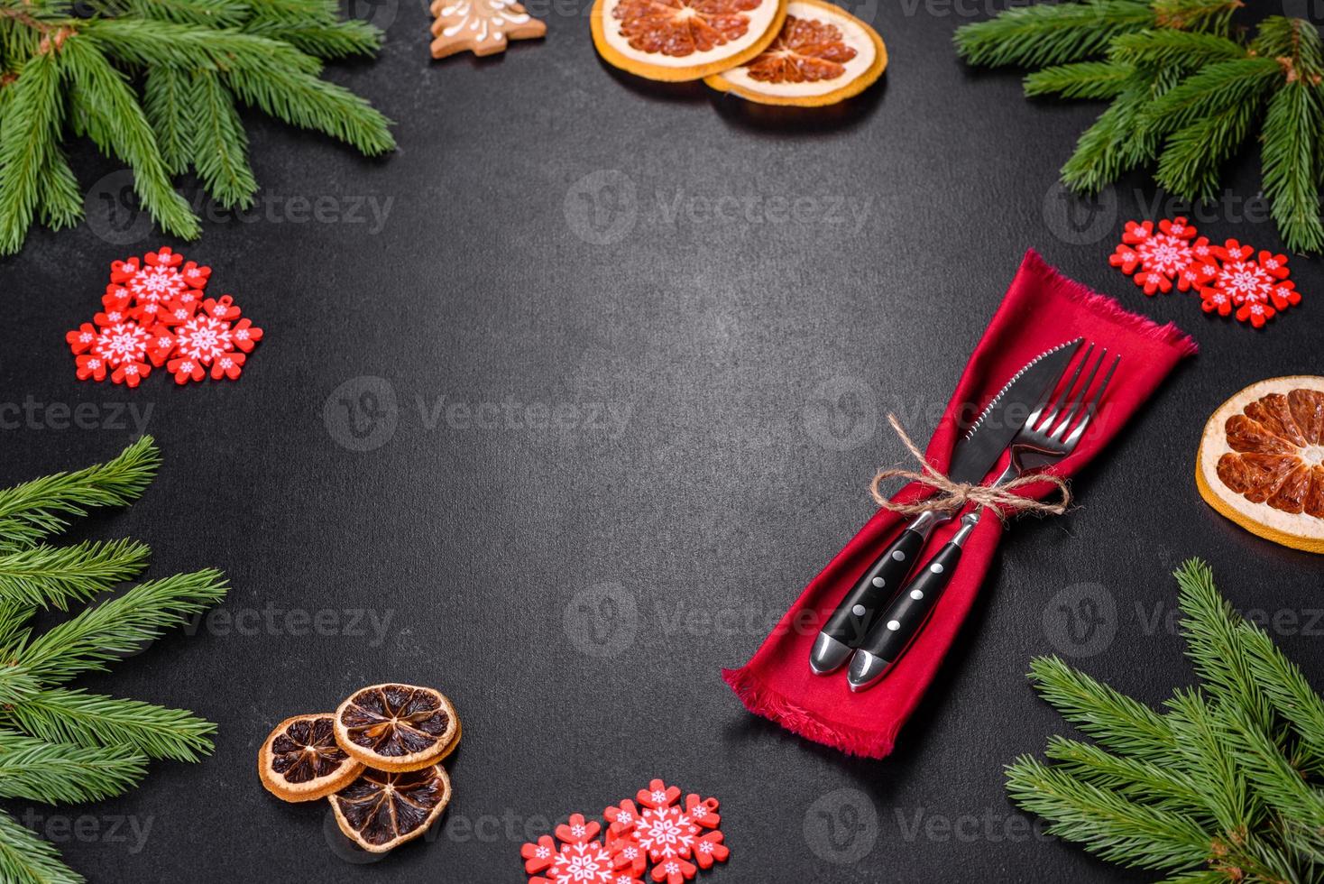Festive Christmas table with appliances, gingerbreads, tree branches and dried citrus trees photo