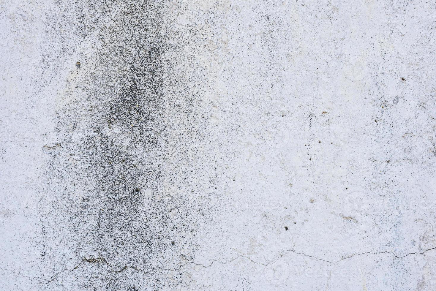 Texture of a concrete wall with cracks and scratches which can be used as a background photo