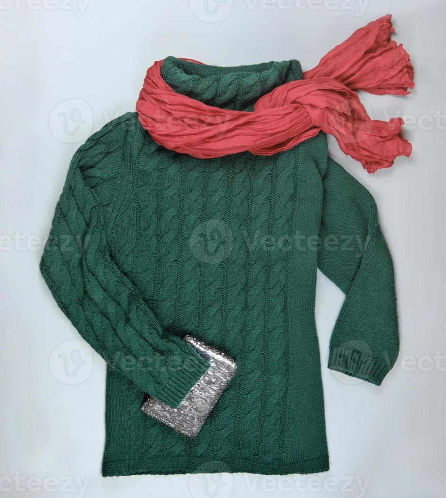 dark green pullover with red scarf and handbag photo