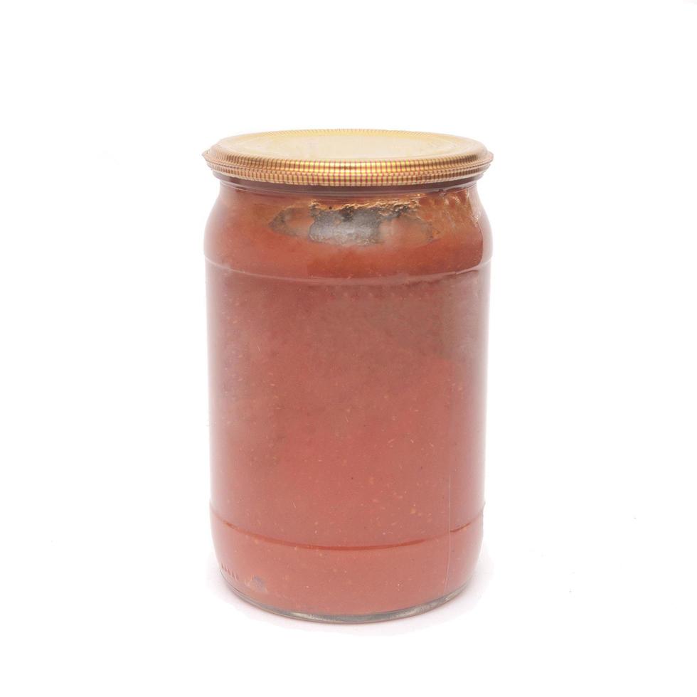 Homemade glass tomato sauce canned food isolated on white background photo