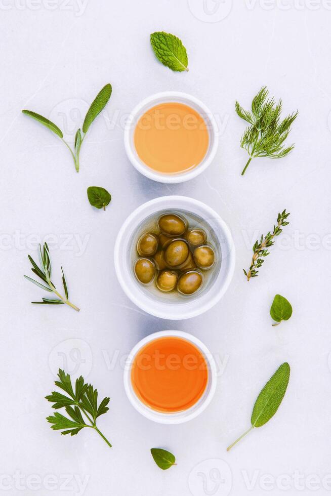 Different sorts of cooking oil,olive oil flavored and Sesame oil with spices set up with marble background concept for international cuisine. photo